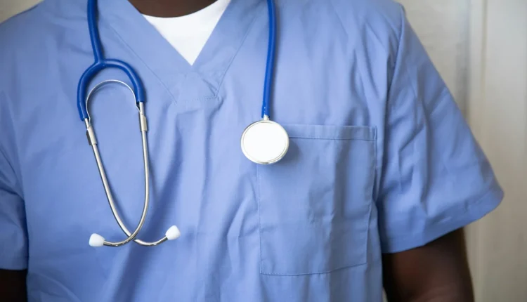 a person wearing a blue shirt with a white circle on it