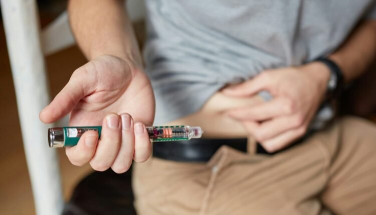 a person holding an insulin injection