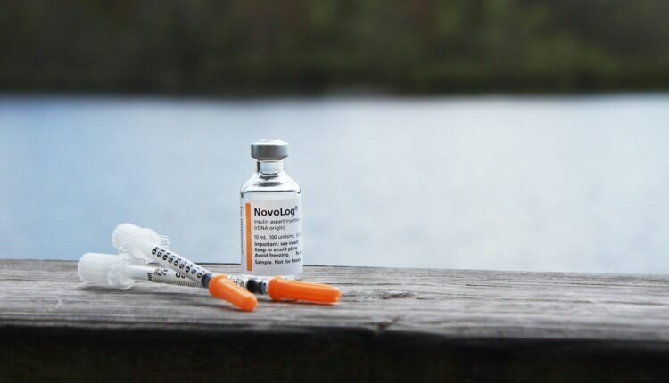orange and white plastic bottle on brown wooden table