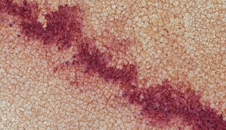 A close up of a red substance on a surface