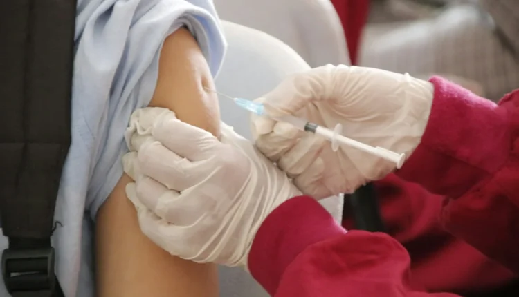 a person in a red shirt and white gloves