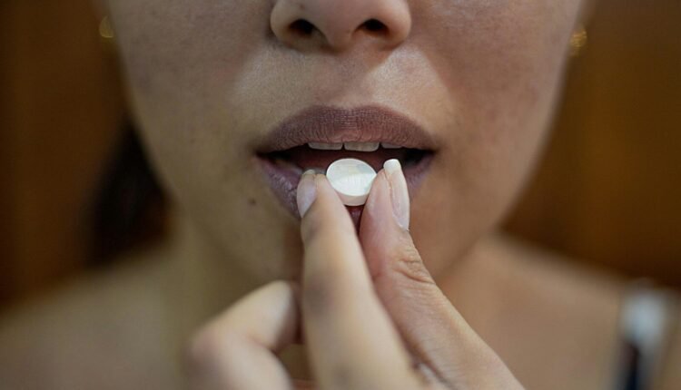 woman putting her hand on her lips