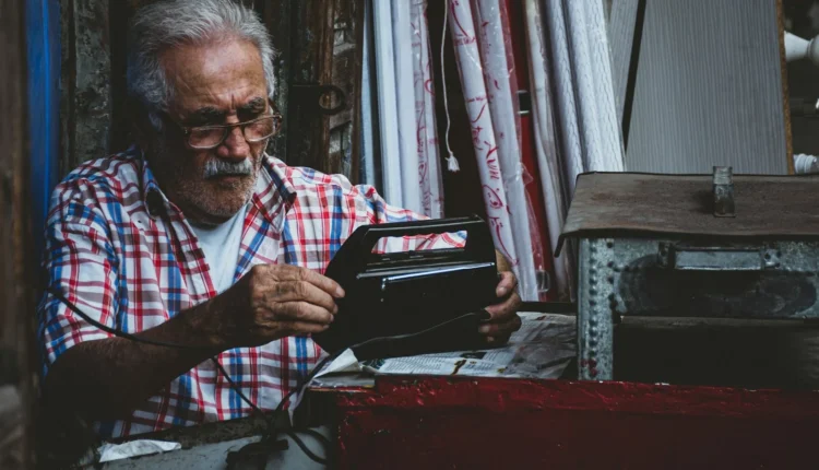 an old man is looking at a wallet