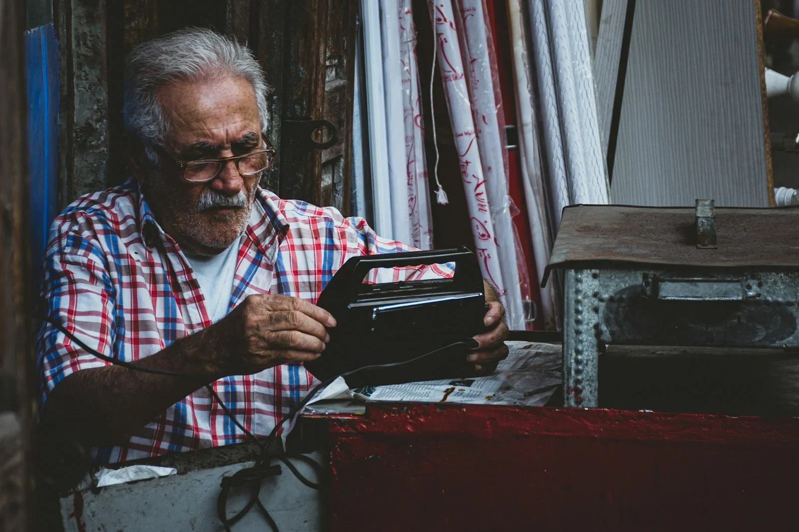 an old man is looking at a wallet
