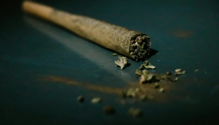 brown cigarette stick on blue surface