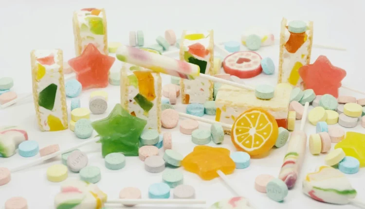 a pile of colorful candies on a white surface