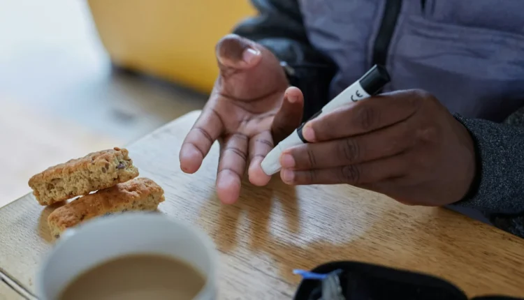 a person doing a finger prick test for blood glucose