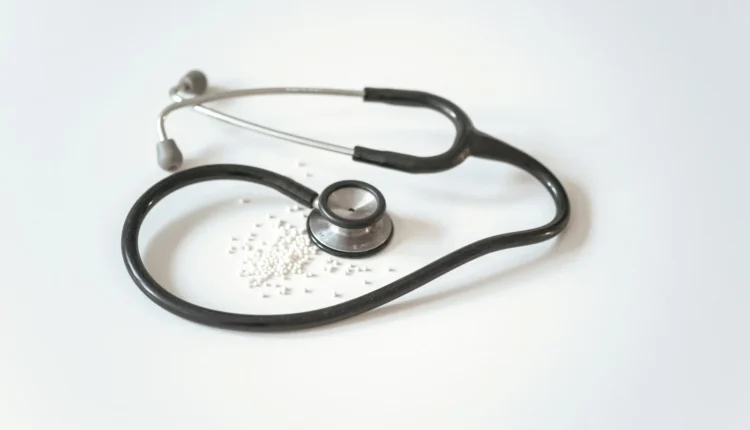 black and silver stethoscope on white surface